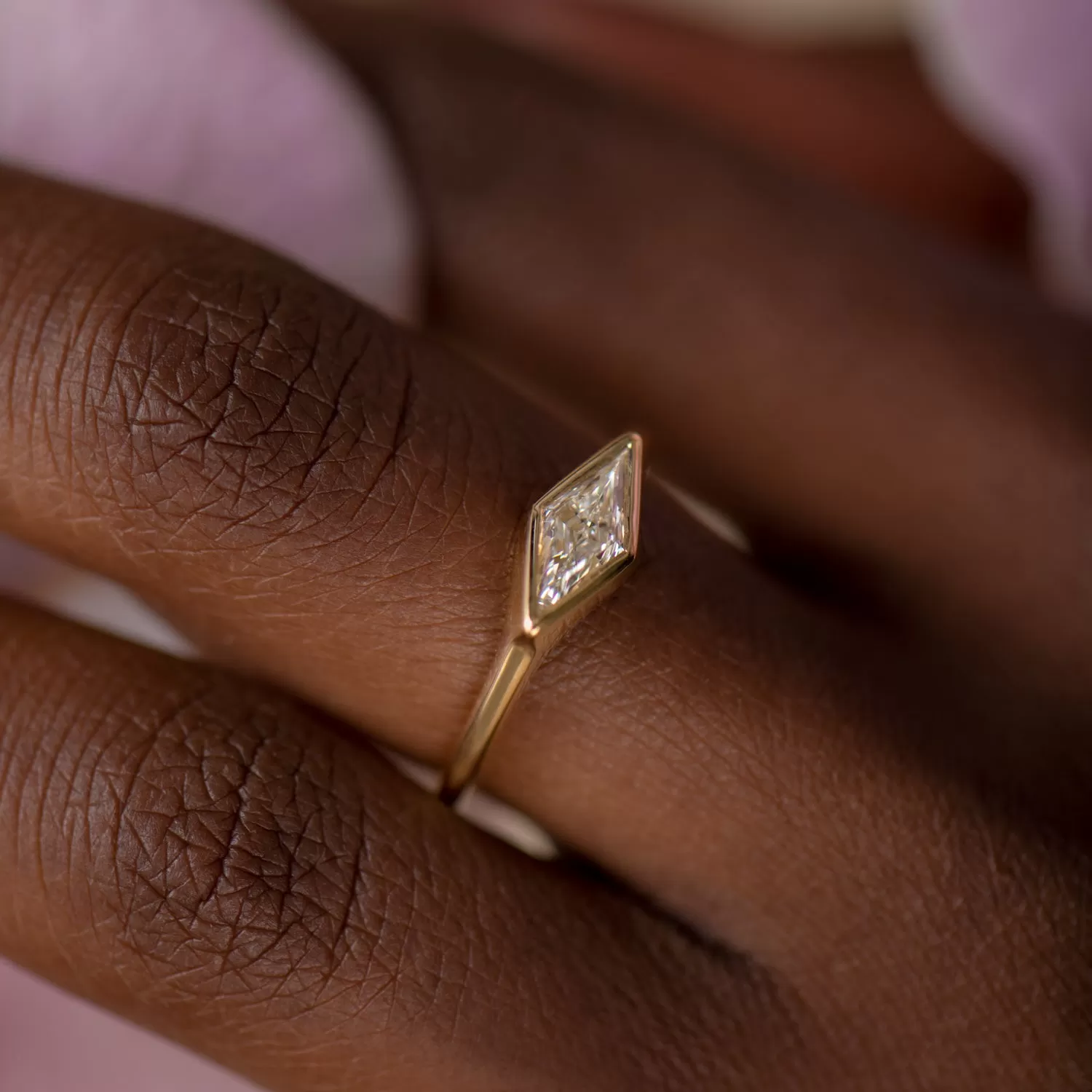 Lozenge Cut Diamond Engagement Ring with a Golden Bezel